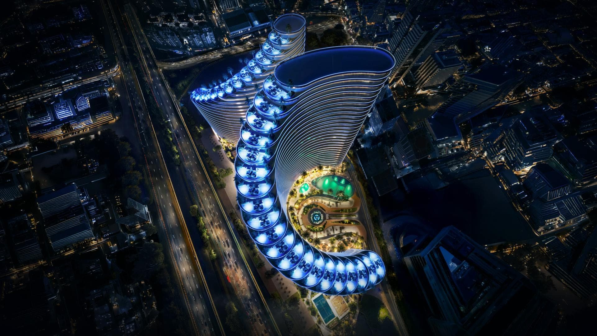 Render of Binghatti Skyflame from directly above at night, showing the curved plan of the two towers