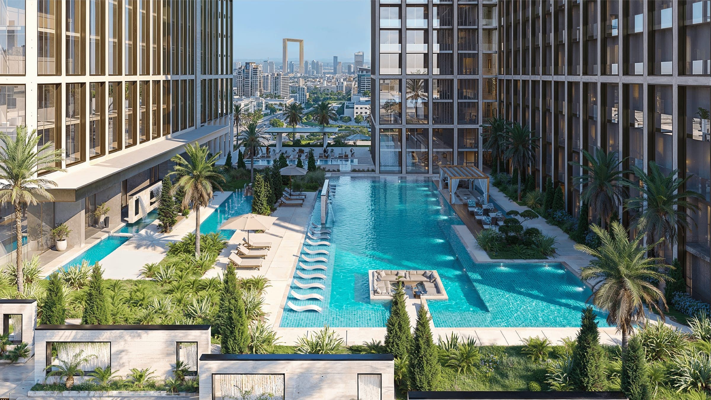 Render of the podium pool deck at Binghatti Spectre, with loungers and planting alongside the water