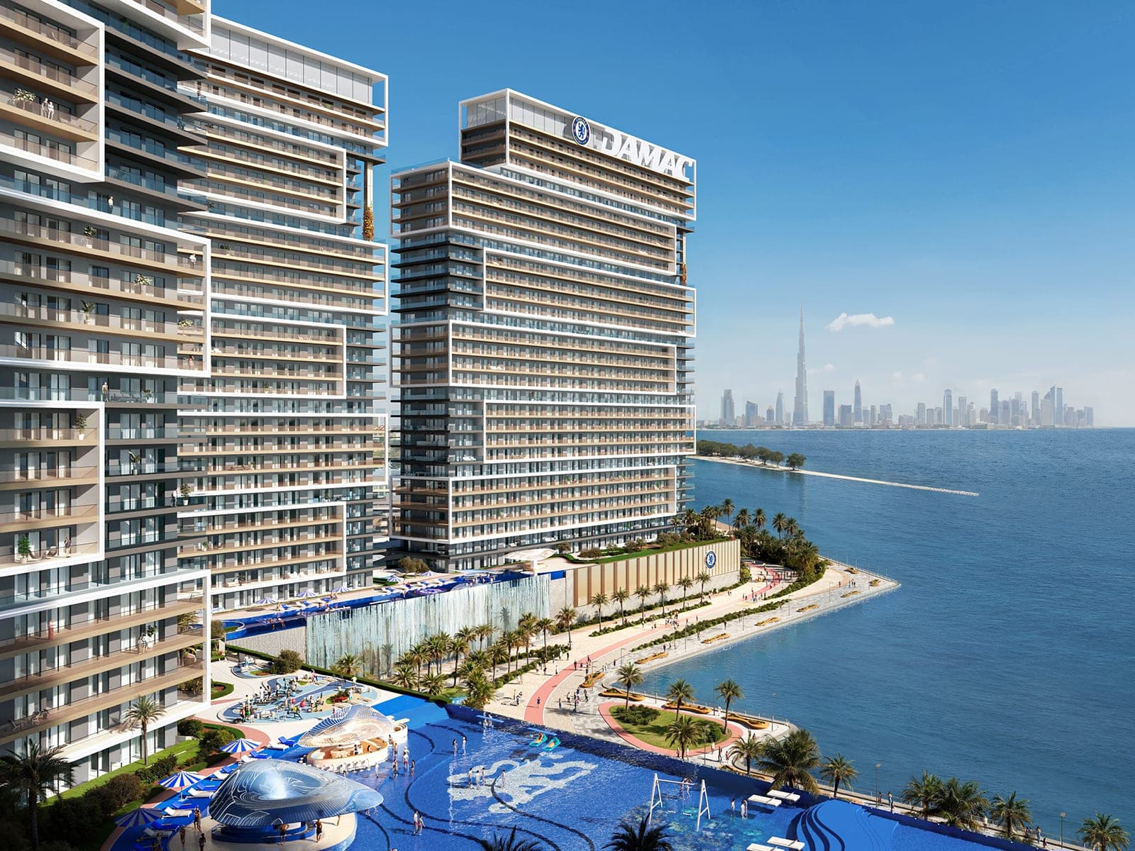 Render of Chelsea Residences by DAMAC from the air, showing the beachfront, the pool lagoon and the Downtown Dubai skyline in the distance