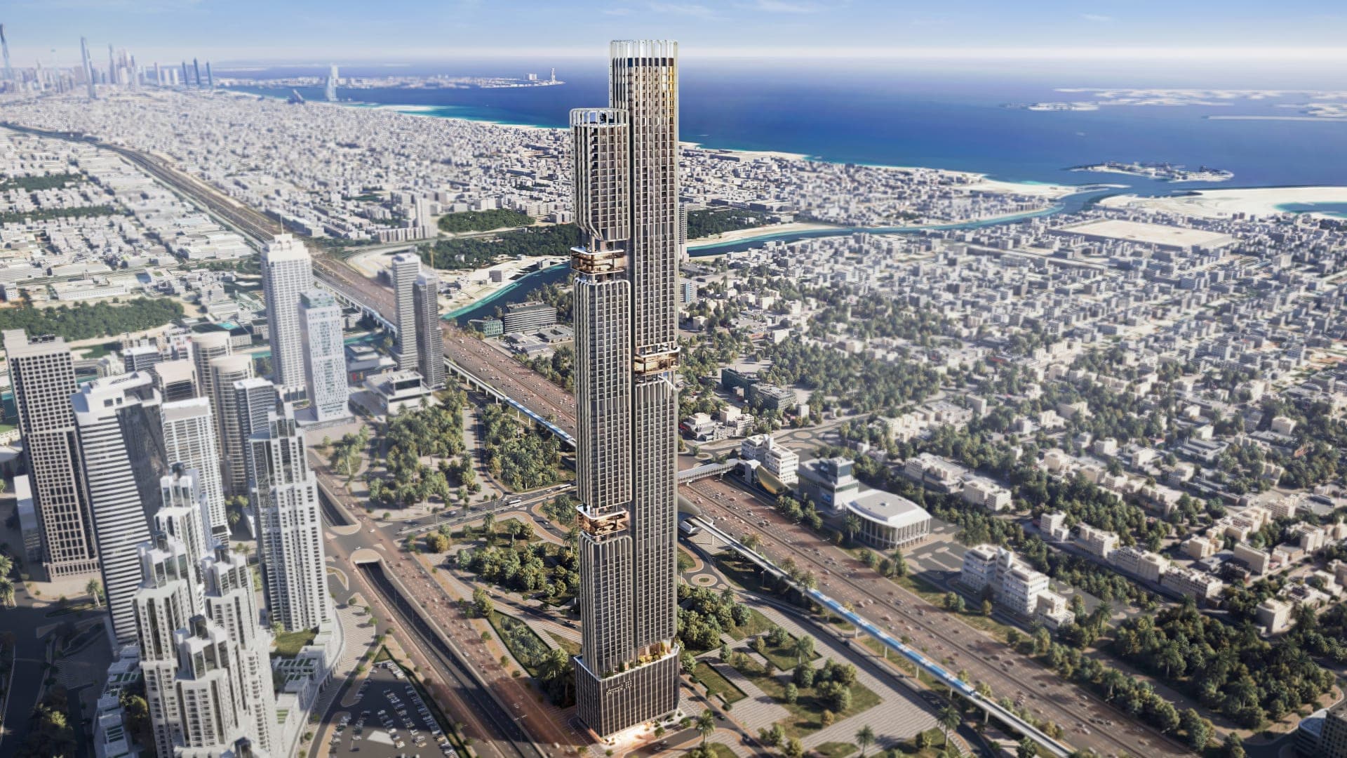 Render of the stepped twin tower of DWTN Residences from the air, rising beside a highway with the city and coastline stretching behind