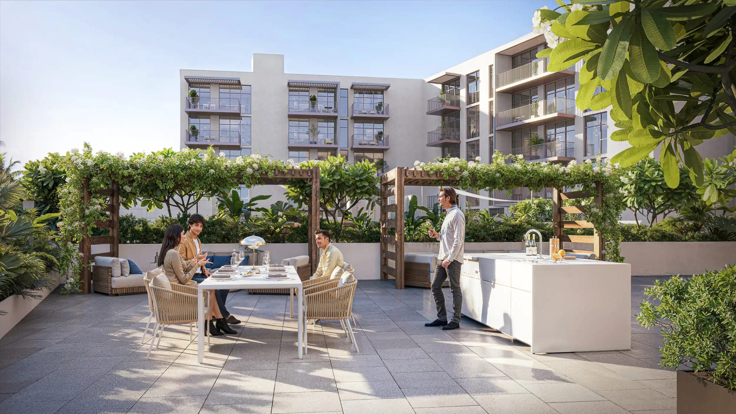 Render of the barbecue terrace at IR1DIAN Park, with a dining table and an outdoor kitchen beneath flowering pergolas