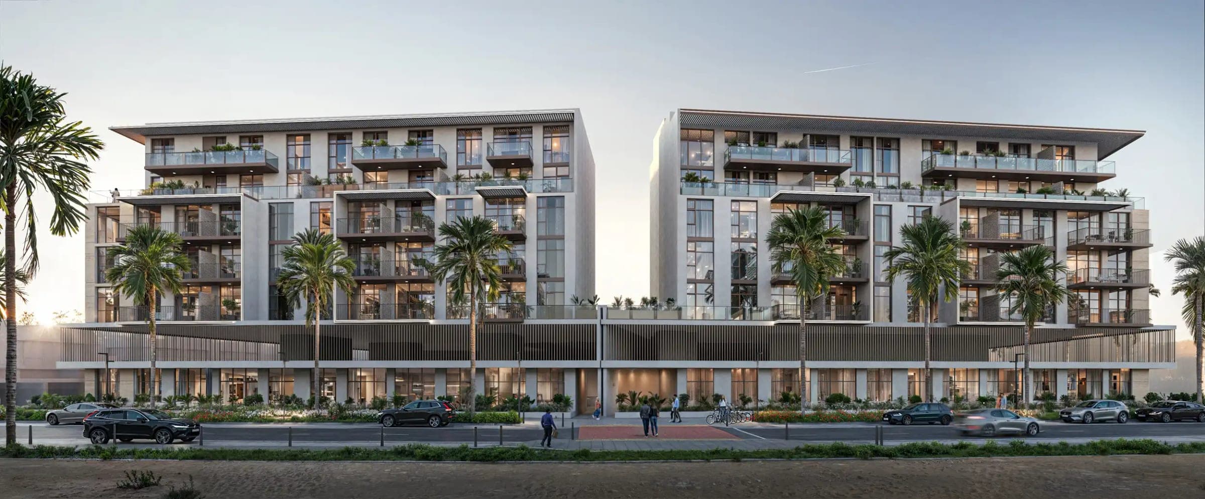 Render of IR1DIAN Park in Jumeirah Village Circle, two residential blocks with planted balconies above a shared ground-floor podium on a palm-lined street