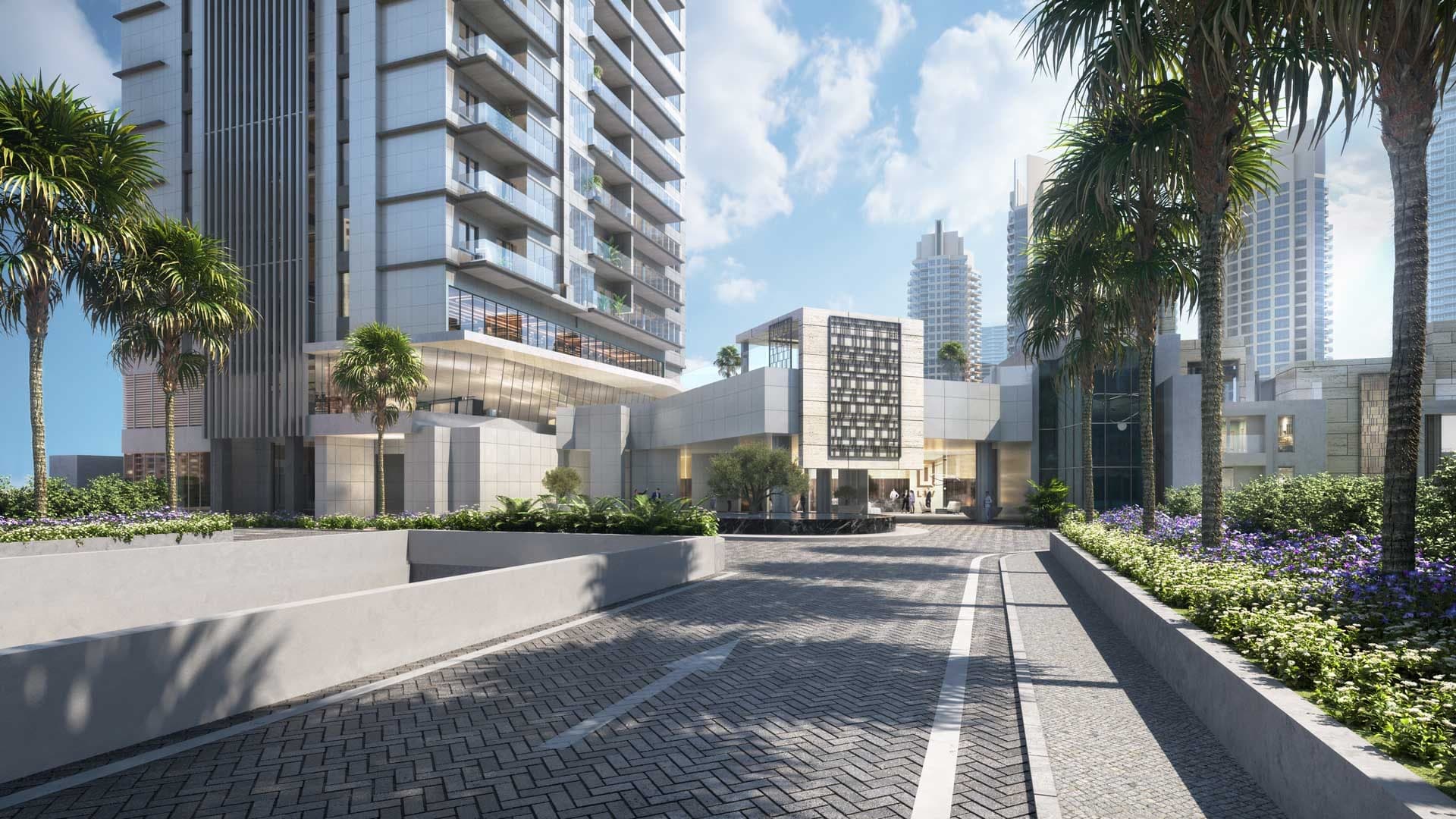 Render of the arrival court at LIV Waterside in Dubai Marina, a paved drive between planted beds leading to the lobby entrance at the base of the tower