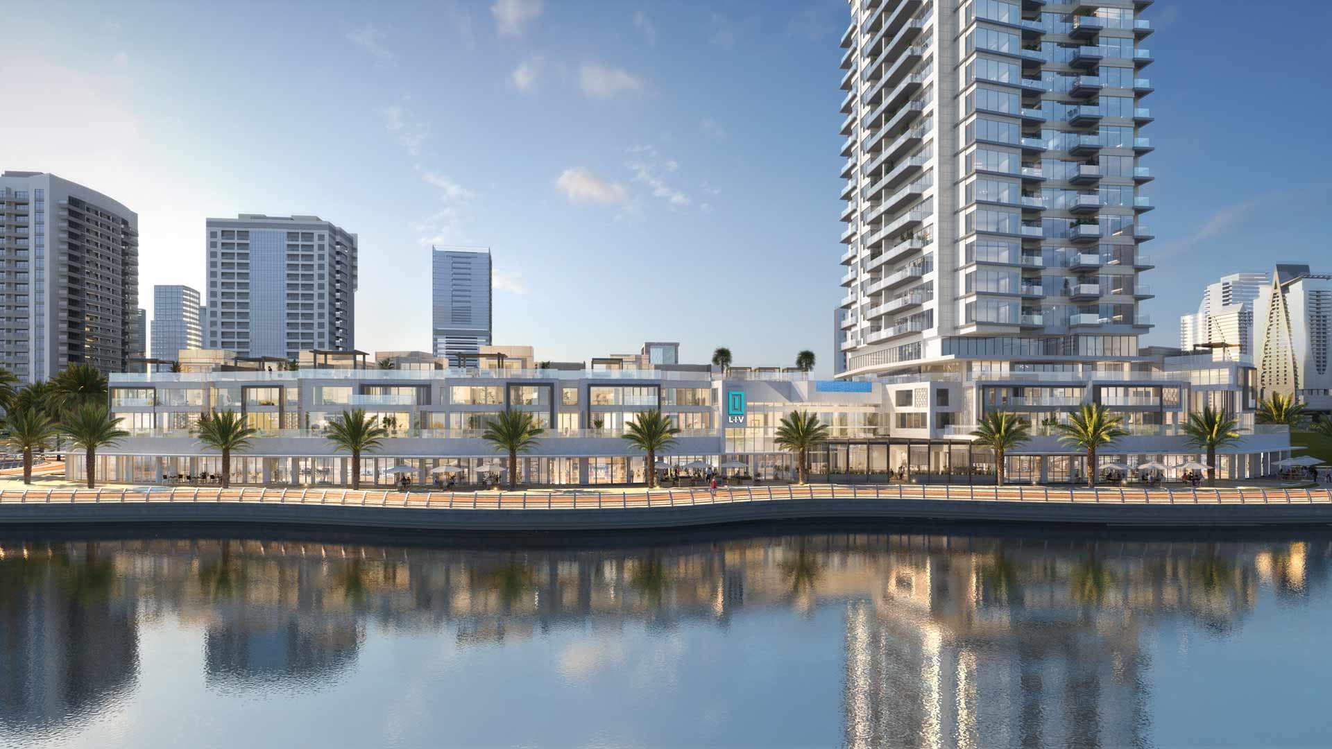 Render of LIV Waterside seen across the Dubai Marina water, terraced villas above waterfront cafes at the foot of the tower