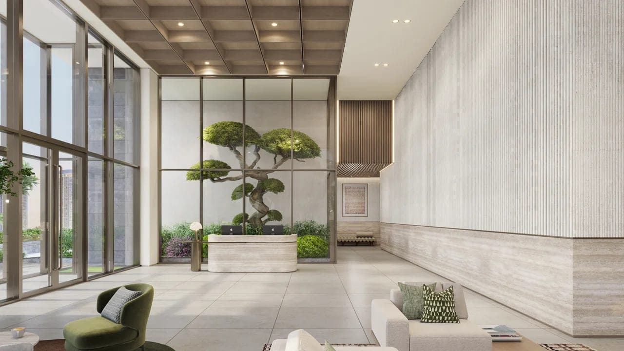 Render of the residents' reception lobby at Nirvana Residences I, with a double-height planted courtyard beyond the glazing