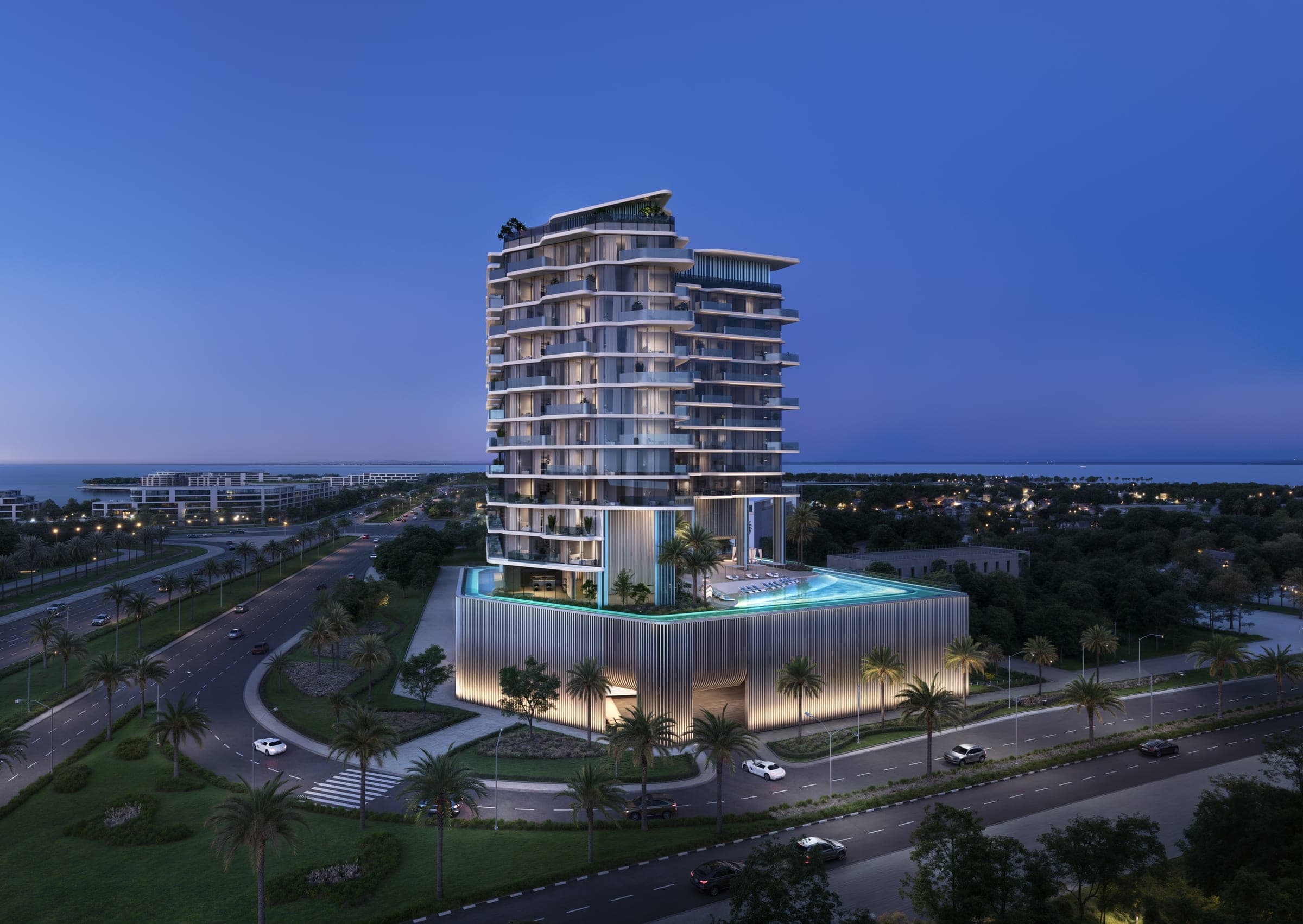 Render of OCTA Isle Interiors by Missoni on Dubai Islands at dusk, the tower and its rim-lit podium pool beside palm-lined roads with the sea beyond