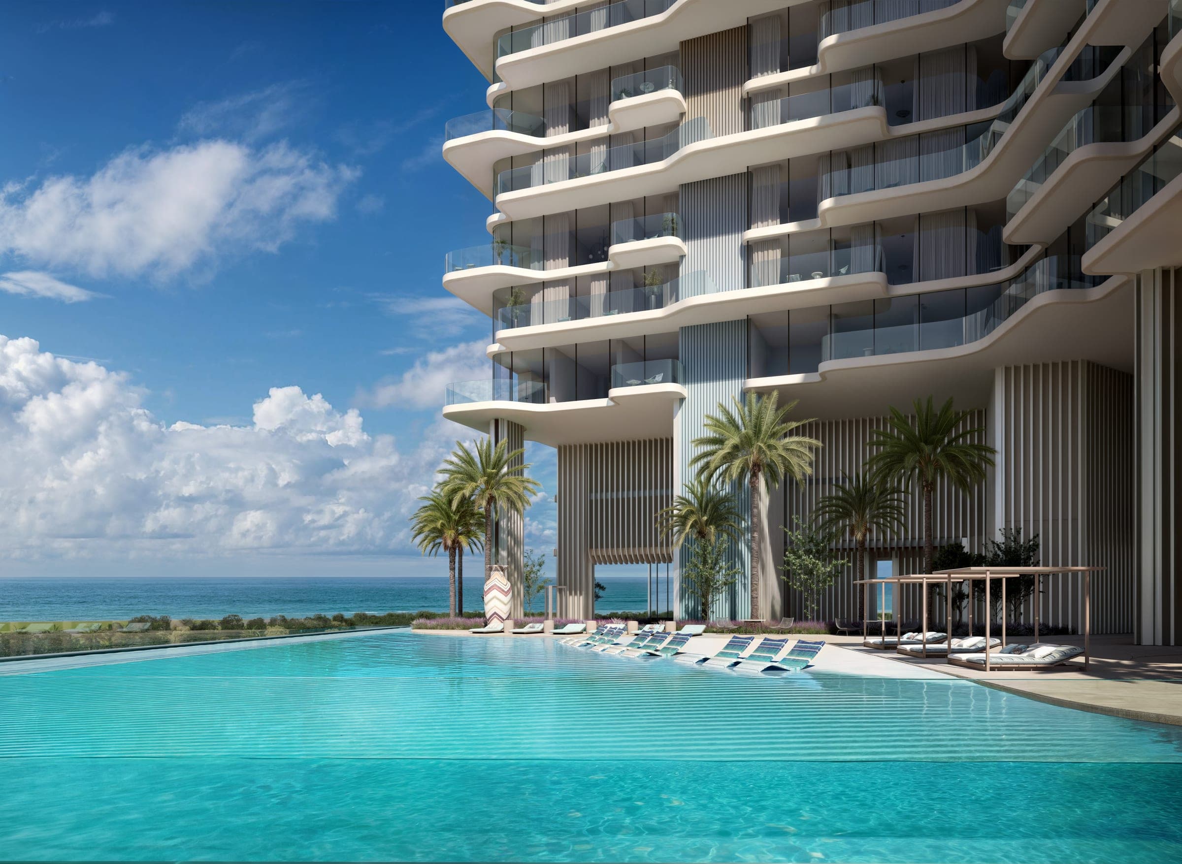 Render of the infinity pool at OCTA Isle Interiors by Missoni, palms and loungers below the curved balconies with the sea on the horizon