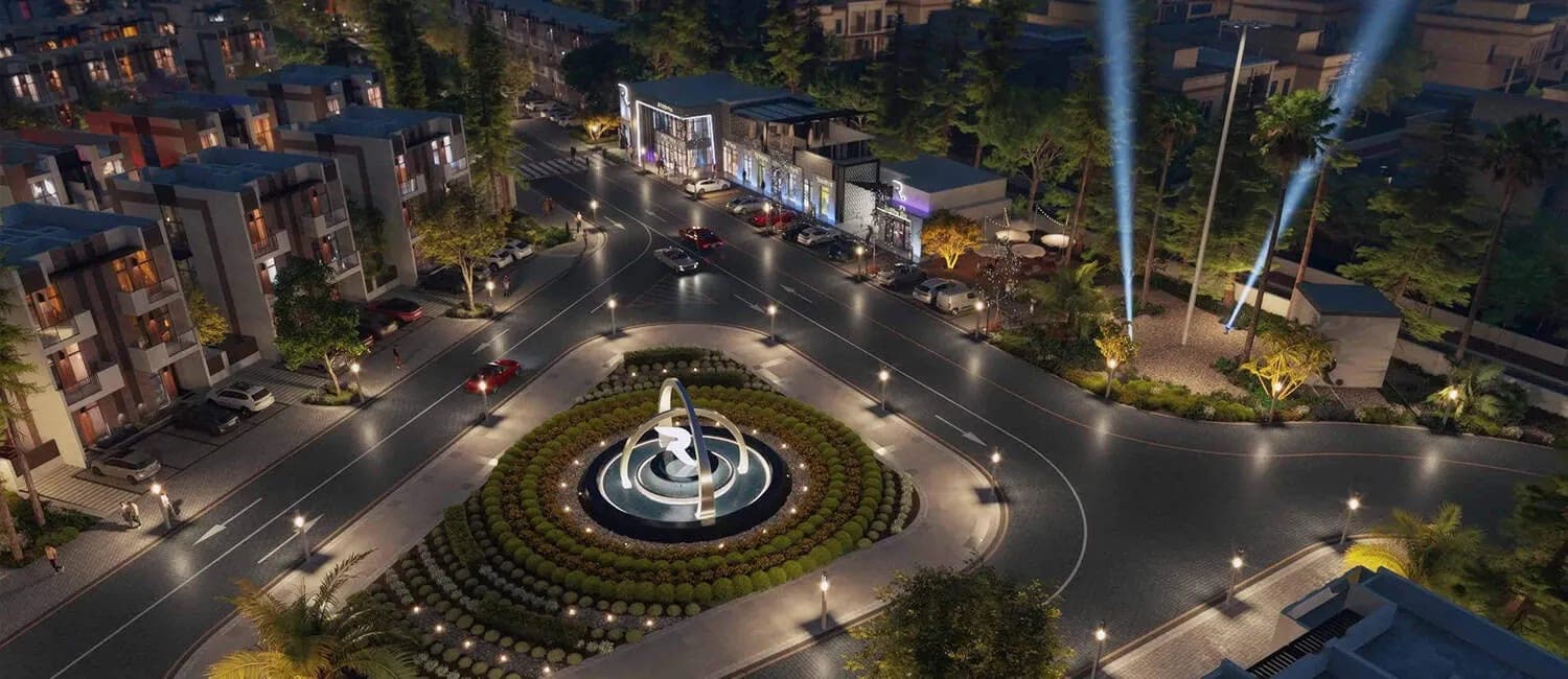 Render of the lit roundabout and retail frontages at R. Hills at night