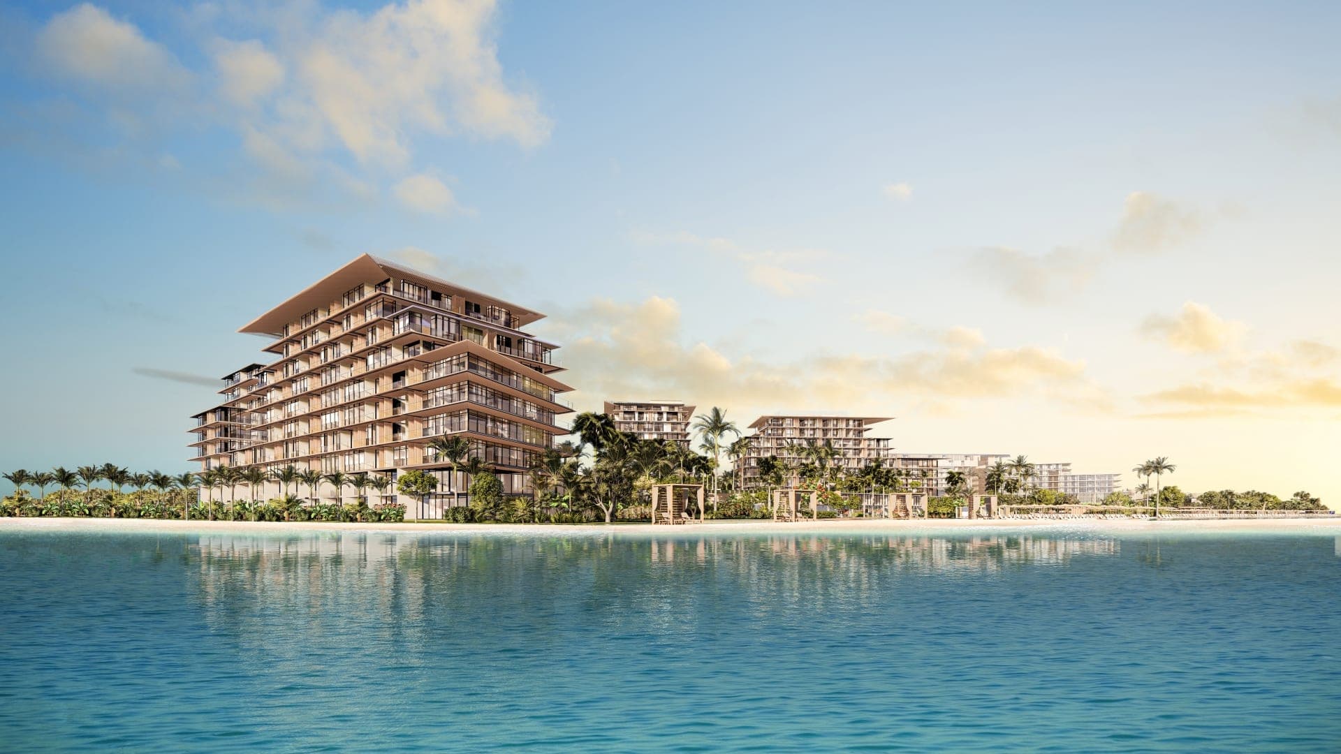 Render of Rixos Hotel & Residences, Dubai Islands seen from the sea, the stepped buildings behind a white-sand beach