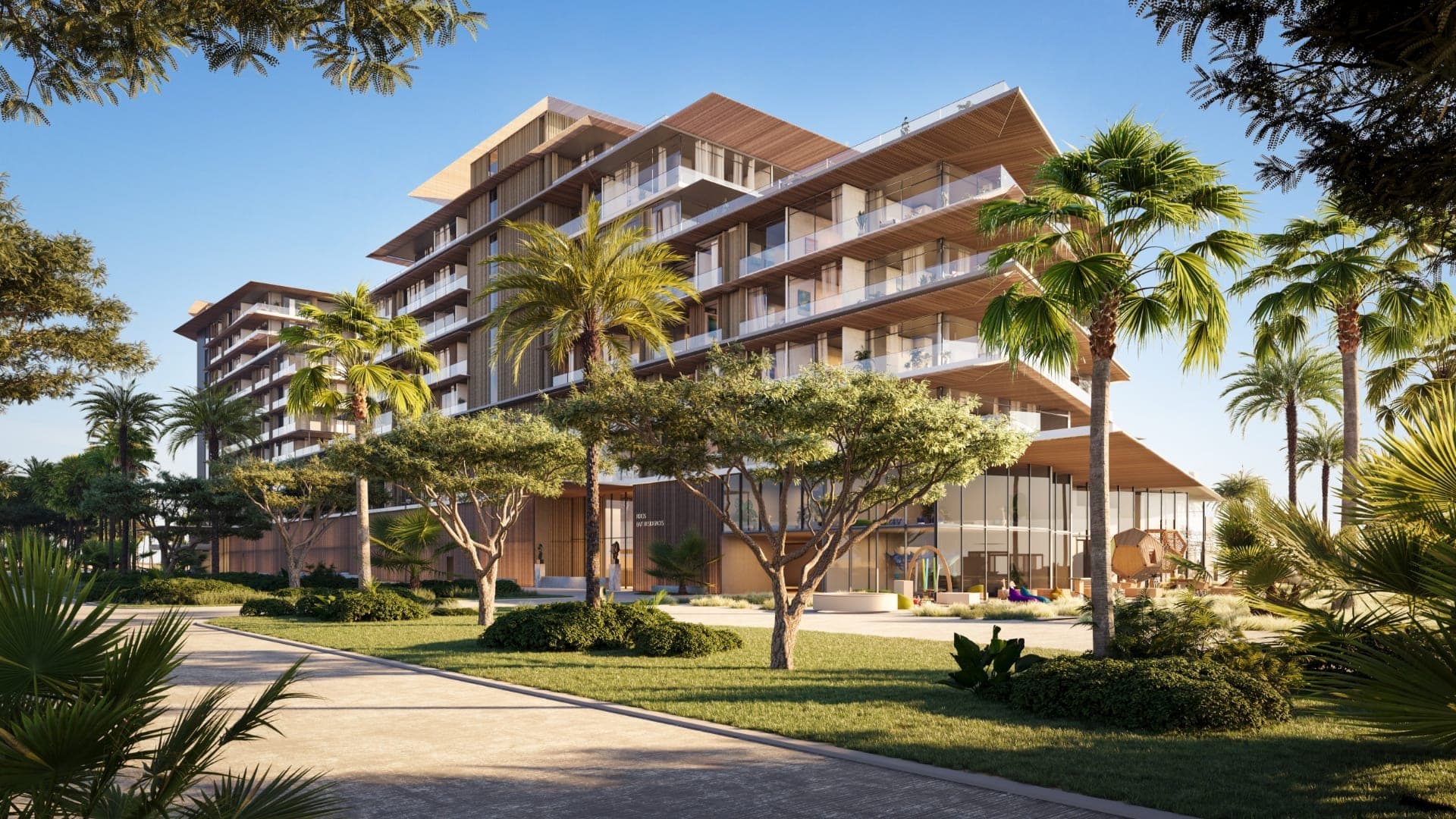 Render of a Rixos residences building at Dubai Islands, with terraced balconies above a landscaped garden and palm trees