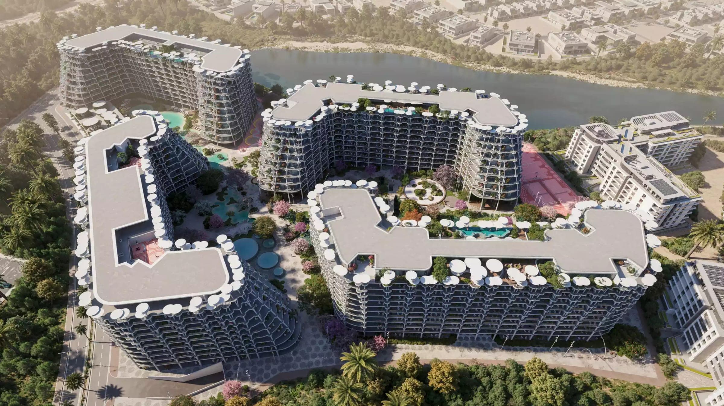 Render of the buildings of Sakura Gardens by HRE Development set around their landscaped podium beside the Falcon City lagoon, seen from the air