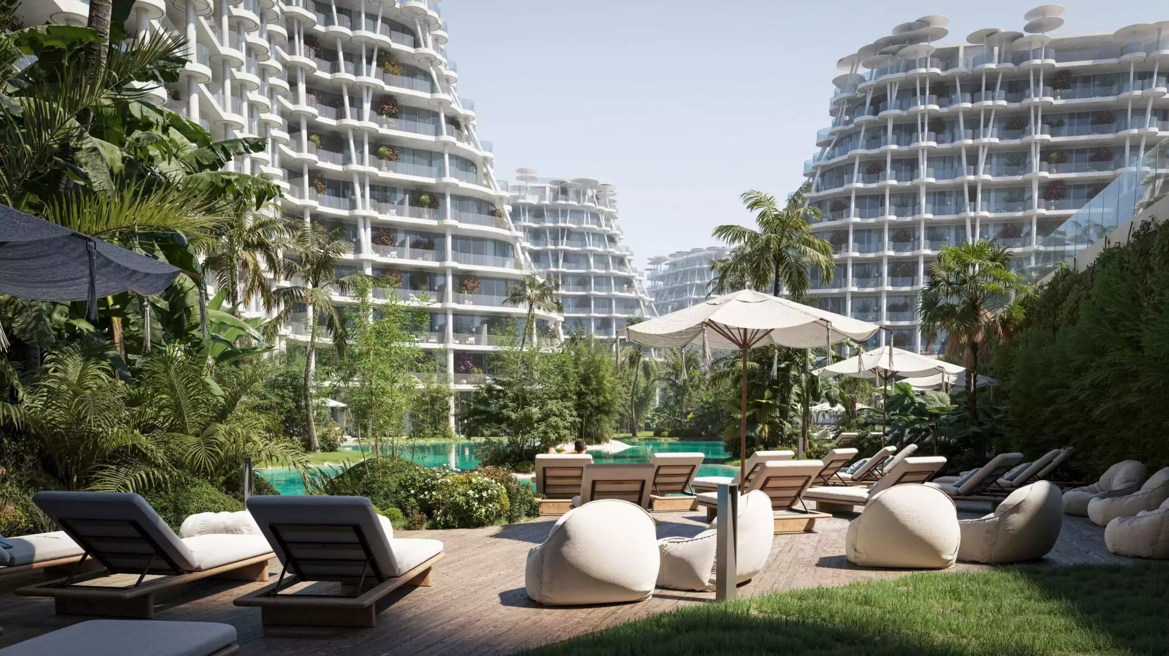 Render of the pool deck and sun loungers between the buildings at Sakura Gardens by HRE Development