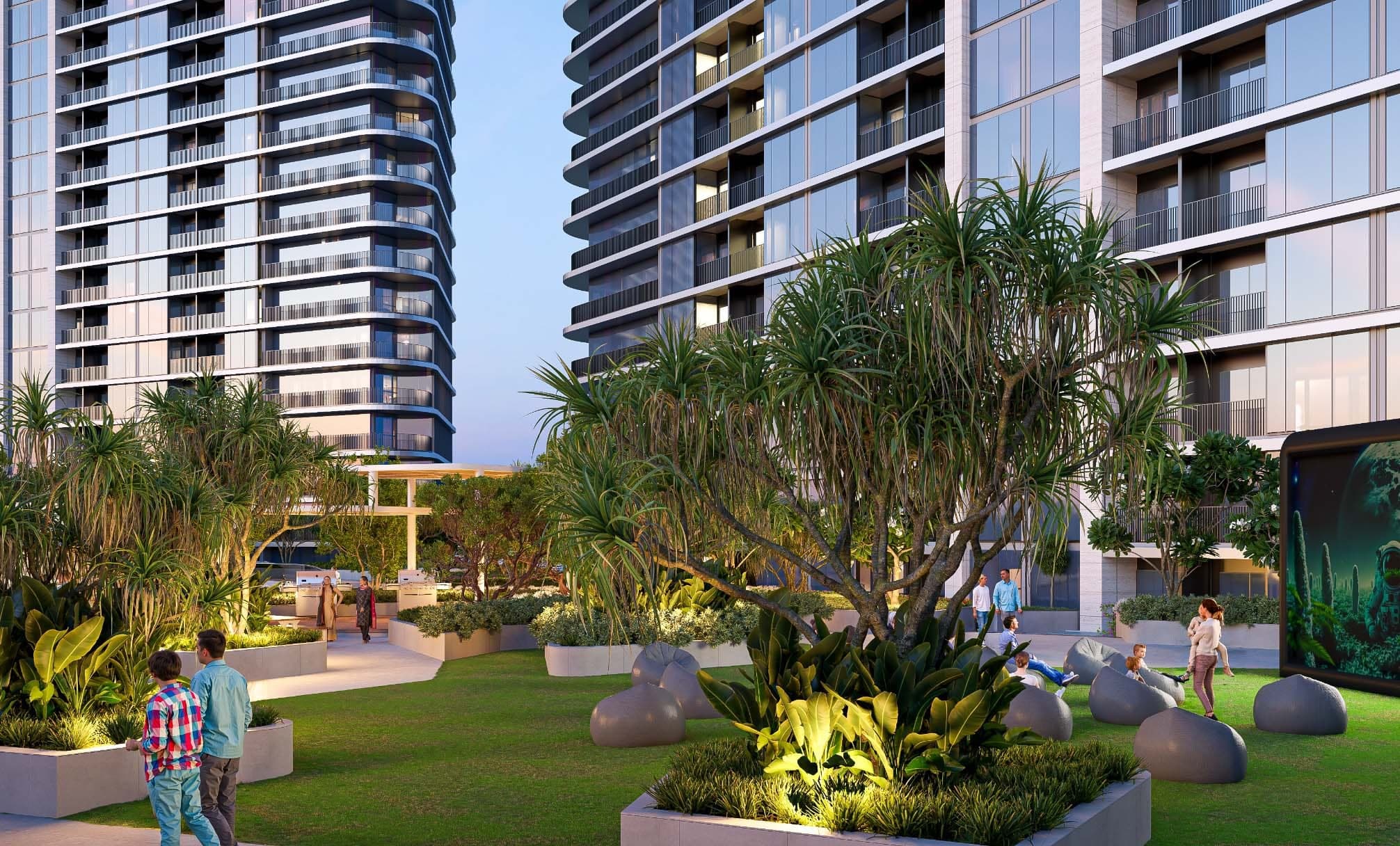 Render of the landscaped podium garden at Sobha Solis at dusk, with lit lawns, planting and the towers rising behind