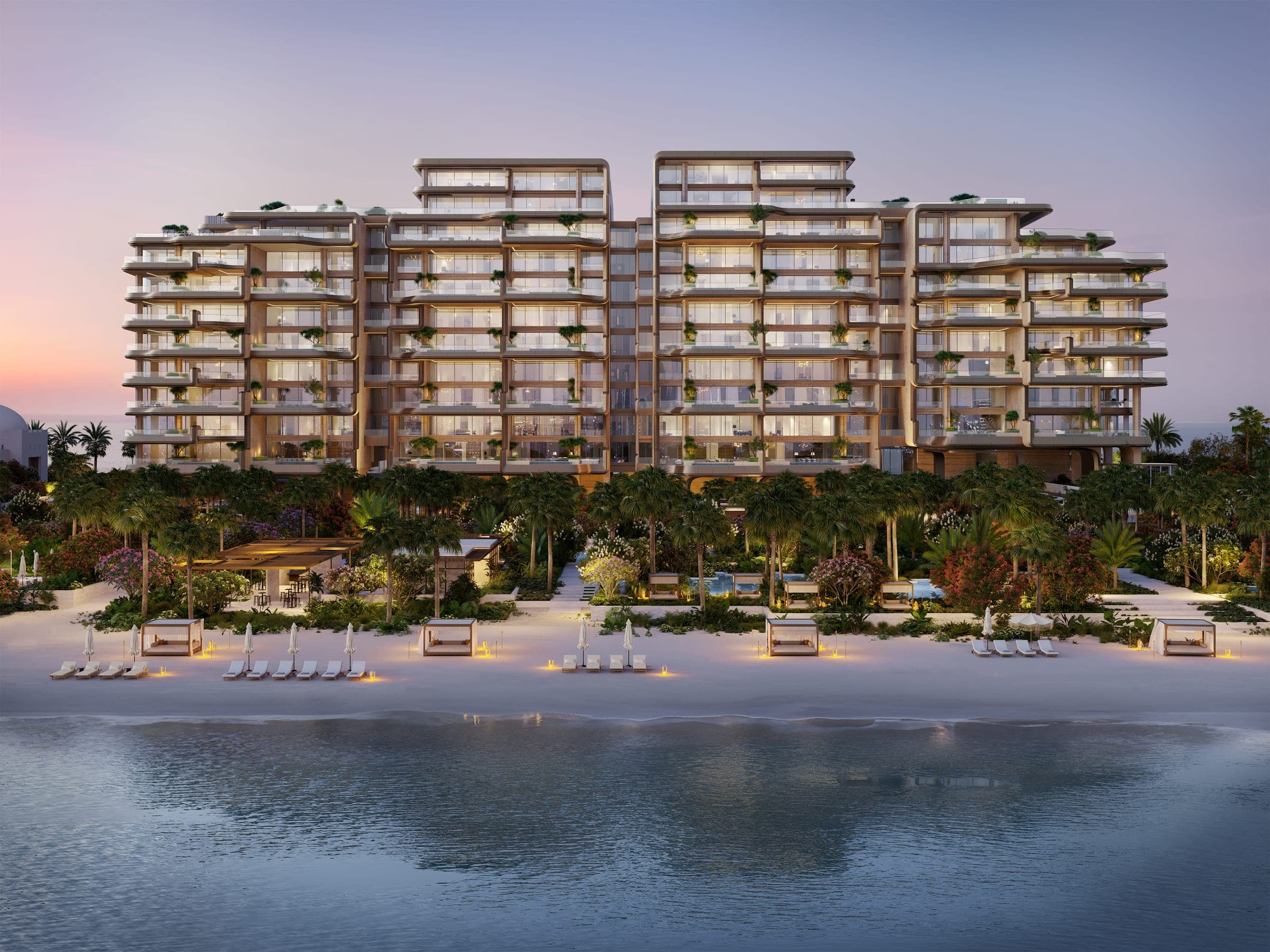 Render of The Alba Residences on Palm Jumeirah at dusk, the terraced facade seen across the water above the beach and gardens