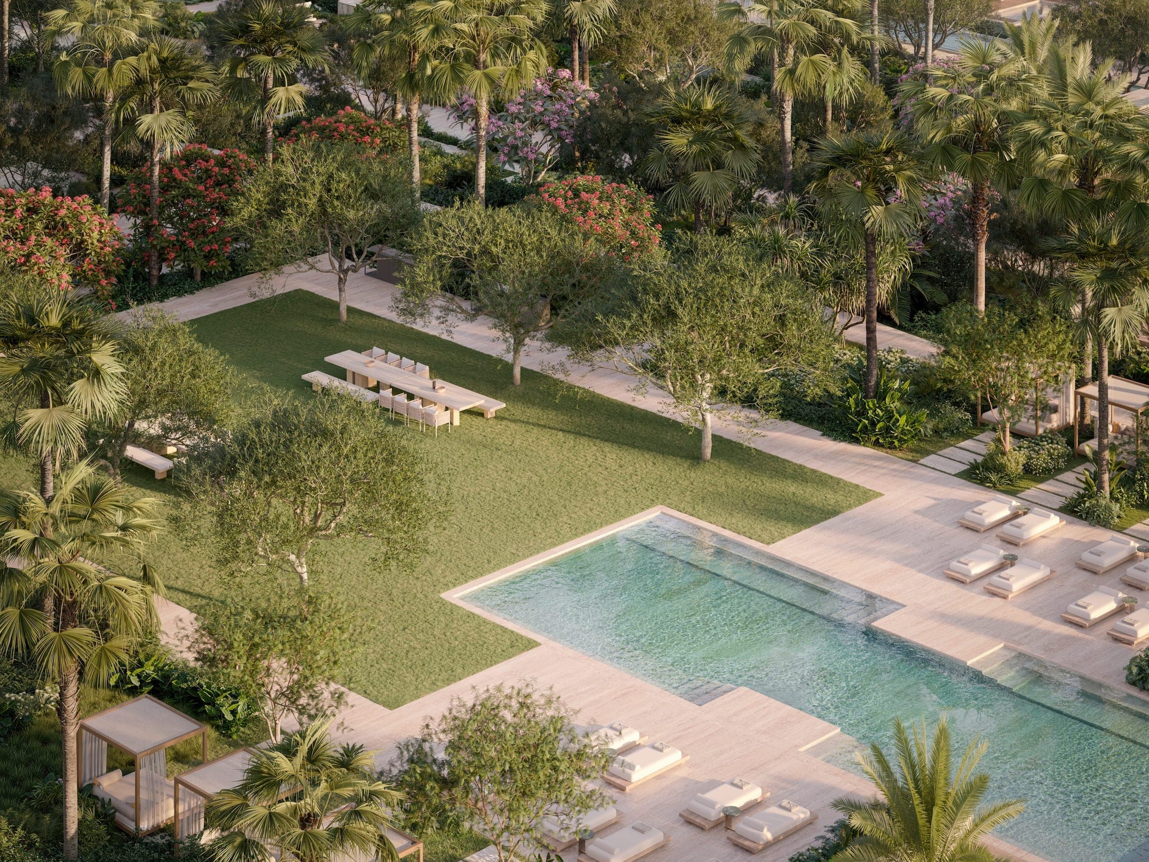 Render of The Alba Residences gardens from above, a lawn with a long dining table beside a pool and loungers