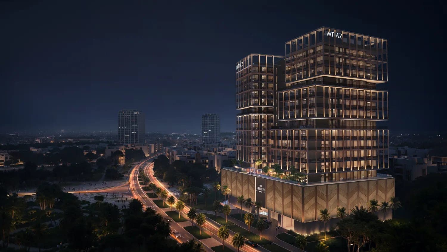 Render of The Archive by Imtiaz seen from the air at dusk, with the highway and the surrounding DubaiLand Residence Complex blocks around it