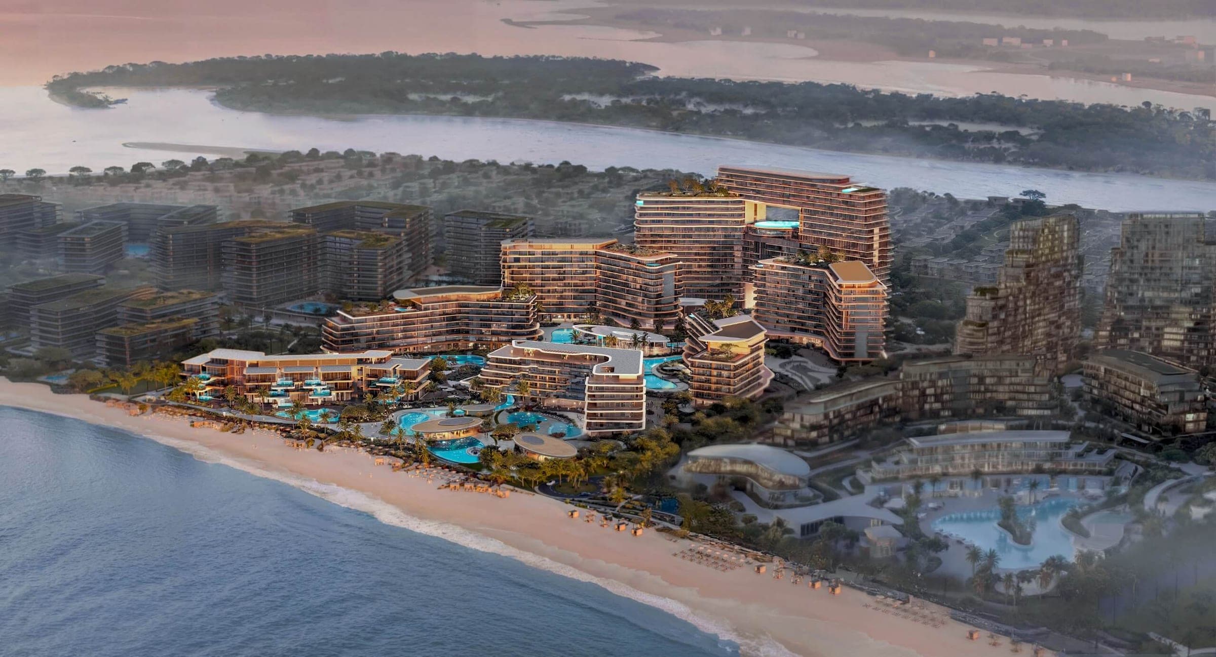 Render of The Meriva Collection on Dubai Islands from the air at sunset, stepped buildings and pool terraces behind a long sandy beach