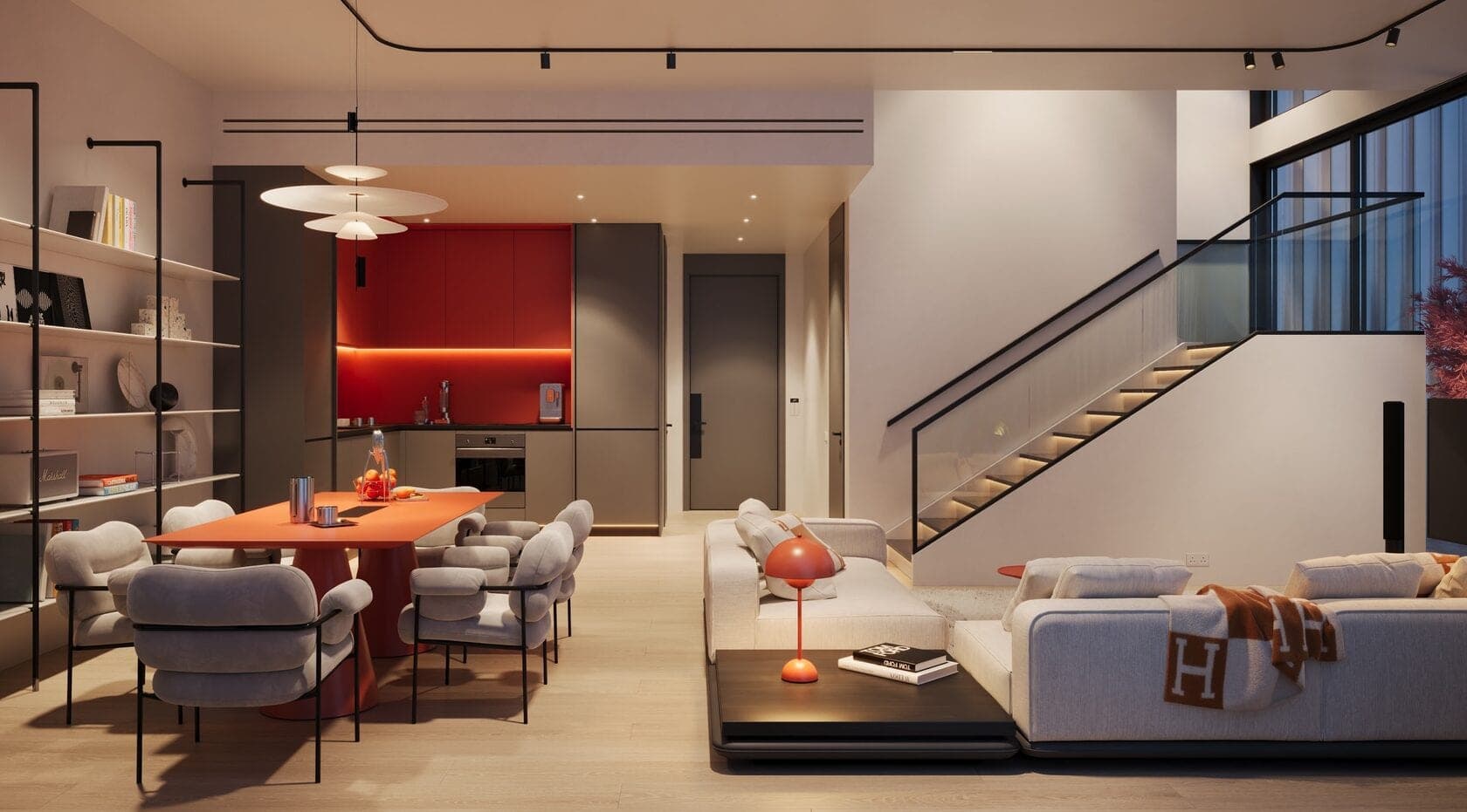 Render of a duplex living and dining room at Villa dell'Arte on Dubai Islands in the evening, with a red kitchen, an orange dining table and a lit staircase