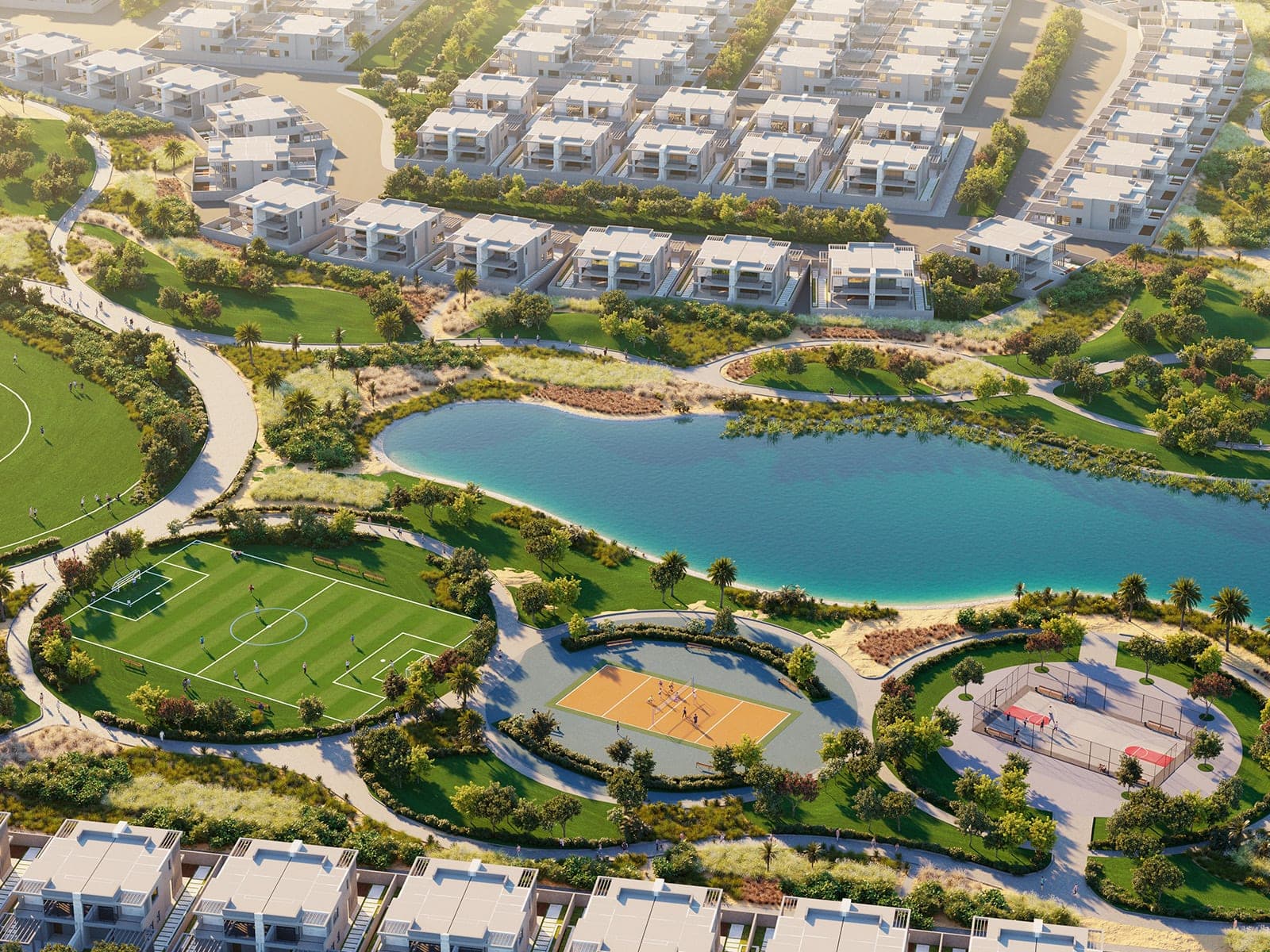 Render of DAMAC Hills 2 from above, a lake with a football pitch, a volleyball court and a caged padel court along its near shore, the edge of a cricket ground at left, and rows of two-storey homes behind and in front