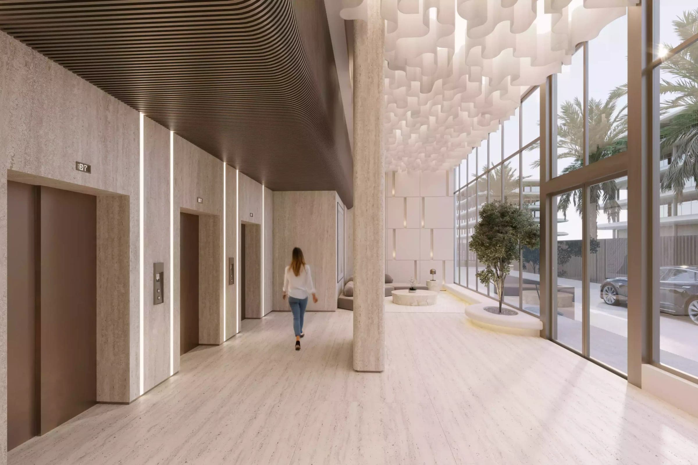 Render of the ground-floor lift lobby at Wadi Hills by HRE Development, with stone walls and a full-height glazed frontage