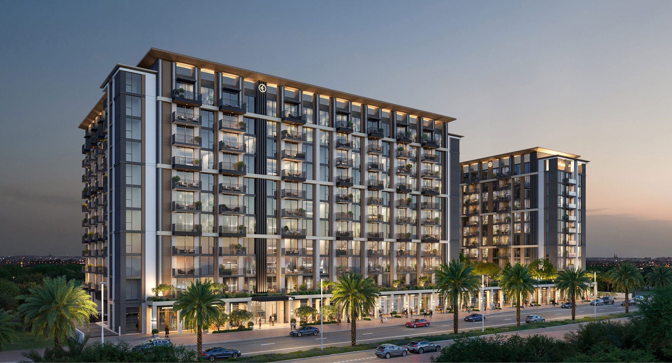 Render of two Windsor House apartment buildings by Ellington in Dubai South at dusk, balconied facades above a palm-lined street with shops at ground level